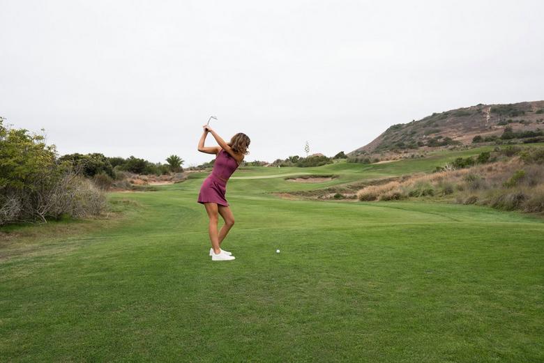 Professional golfer taking a swing.